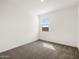 Neutral bedroom with carpet, a window with blinds, and bright white walls at 35581 N Thicket Way, San Tan Valley, AZ 85144