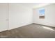 Neutral painted bedroom featuring soft carpeting and a large window for natural light creating an inviting space at 35581 N Thicket Way, San Tan Valley, AZ 85144