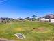 View of the neighborhood park offering open green spaces and playground area at 35581 N Thicket Way, San Tan Valley, AZ 85144