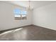 Dining room with tile floors, modern light fixture and a large window at 35581 N Thicket Way, San Tan Valley, AZ 85144