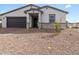 Single-level house with neutral stucco, grey brick accents, and desert landscaping for low maintenance at 35581 N Thicket Way, San Tan Valley, AZ 85144