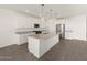 Modern kitchen with white cabinets, granite countertops, and stainless steel appliances at 35581 N Thicket Way, San Tan Valley, AZ 85144