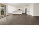 A bright living area showcasing tile flooring and an open layout into the kitchen at 35581 N Thicket Way, San Tan Valley, AZ 85144