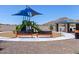 Community playground featuring a colorful playset, benches, and shaded picnic area with mountain views at 35581 N Thicket Way, San Tan Valley, AZ 85144