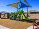 Community playground featuring a covered slide, climbing wall, and picnic area under a shade structure at 35581 N Thicket Way, San Tan Valley, AZ 85144