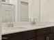 Close up of a dual sink vanity, white countertops, dark cabinets and chrome faucets at 37042 W Prado St, Maricopa, AZ 85138