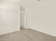 Bedroom featuring neutral carpet, closet with sliding doors, and an adjoining room at 37042 W Prado St, Maricopa, AZ 85138