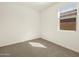 Bedroom featuring neutral carpet, baseboards, and a window providing natural light at 37042 W Prado St, Maricopa, AZ 85138