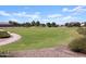 Wide view of the community park with walking path and recreation areas nearby homes at 37042 W Prado St, Maricopa, AZ 85138