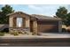 Single-story home with brown garage doors and stone accents at 37042 W Prado St, Maricopa, AZ 85138