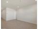 A well-lit living room space with neutral walls and tile flooring, ready for personalization at 37042 W Prado St, Maricopa, AZ 85138