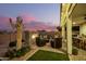 Backyard with fire pit and seating area at sunset at 39725 N Hailey Ln, San Tan Valley, AZ 85140