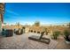 Spacious backyard patio featuring a fire pit and comfortable lounge chairs at 39725 N Hailey Ln, San Tan Valley, AZ 85140