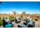 Relaxing backyard patio with seating area, fire pit, and artificial turf at 39725 N Hailey Ln, San Tan Valley, AZ 85140