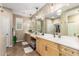 Double vanity bathroom with light wood cabinets and large mirrors at 39725 N Hailey Ln, San Tan Valley, AZ 85140