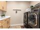 Convenient laundry room with washer, dryer, and cabinets at 39725 N Hailey Ln, San Tan Valley, AZ 85140