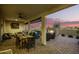 Covered patio with dining area, fireplace, and comfortable seating at 39725 N Hailey Ln, San Tan Valley, AZ 85140