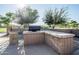 Outdoor grilling station with trash receptacle at 44562 W Sedona Trl, Maricopa, AZ 85139