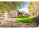 Spacious backyard with grassy area and trees at 44562 W Sedona Trl, Maricopa, AZ 85139