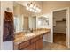 Bathroom features granite double vanity and walk-in closet access at 44562 W Sedona Trl, Maricopa, AZ 85139