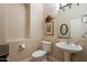 Elegant bathroom with a pedestal sink and decorative accents at 44562 W Sedona Trl, Maricopa, AZ 85139