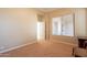 Bright bedroom with neutral walls, window with blinds, and carpeted floor at 44562 W Sedona Trl, Maricopa, AZ 85139