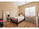 Bedroom with a full-size bed, dresser, and large mirror at 44562 W Sedona Trl, Maricopa, AZ 85139