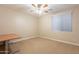 Bright bedroom with ceiling fan and carpeted floor at 44562 W Sedona Trl, Maricopa, AZ 85139