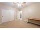 Bedroom with ceiling fan, closet, and workspace at 44562 W Sedona Trl, Maricopa, AZ 85139