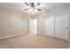 Bedroom with ceiling fan and double closet at 44562 W Sedona Trl, Maricopa, AZ 85139