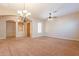 Dining room with carpet, chandelier, and access to other rooms at 44562 W Sedona Trl, Maricopa, AZ 85139