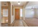 Bright entryway with tile flooring, wood door, and views into the living room at 44562 W Sedona Trl, Maricopa, AZ 85139