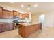 Island kitchen with granite countertops and stainless steel appliances at 44562 W Sedona Trl, Maricopa, AZ 85139