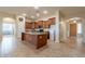 Kitchen boasts an island, granite countertops, and ample cabinet space at 44562 W Sedona Trl, Maricopa, AZ 85139