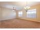 Living room with carpet, chandelier, and large windows at 44562 W Sedona Trl, Maricopa, AZ 85139