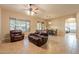 Open living area with leather furniture and adjacent dining area at 44562 W Sedona Trl, Maricopa, AZ 85139