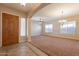 Spacious living room featuring neutral carpeting and a ceiling fan at 44562 W Sedona Trl, Maricopa, AZ 85139