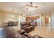 Spacious living room features tile floors and a large leather couch at 44562 W Sedona Trl, Maricopa, AZ 85139