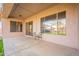 Covered patio with two chairs, offering relaxing space at 44562 W Sedona Trl, Maricopa, AZ 85139