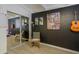 Bedroom with a rocking chair, guitar, and a sleek black accent wall at 4754 N 14Th St, Phoenix, AZ 85014