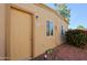 Tan stucco exterior with a single door and small landscaping at 4754 N 14Th St, Phoenix, AZ 85014