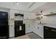 Modern kitchen with white cabinets, black appliances, and wood-look flooring at 4754 N 14Th St, Phoenix, AZ 85014