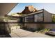 Modern home with concrete and metal exterior, mountain views, and car at 4975 E Mcdonald Dr, Paradise Valley, AZ 85253