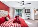 Red and white bedroom with a large bed and backyard access at 5040 N Arcadia Dr, Phoenix, AZ 85018