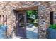 Elegant entry gate opens to a beautifully landscaped backyard with stonework and lush greenery at 5040 N Arcadia Dr, Phoenix, AZ 85018