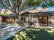 Home exterior showcasing stonework and large tree at 5040 N Arcadia Dr, Phoenix, AZ 85018