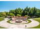 Circular fire pit area with seating and beautiful landscaping at 5040 N Arcadia Dr, Phoenix, AZ 85018