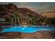 Stunning pool with fountains, fire pit, and mountain backdrop at 5040 N Arcadia Dr, Phoenix, AZ 85018