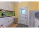 Retro kitchen with white cabinets, green tile backsplash and appliances at 522 W Roosevelt St, Phoenix, AZ 85003