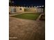 Outdoor space with pavers, artificial turf, shed, and string lights creates a cozy backyard retreat at 6207 W Acoma Dr, Glendale, AZ 85306